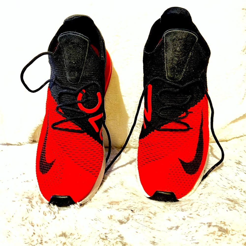 Nike Air Max 270. The shoes have a red with black synthetic upper material.